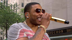 A Man In Sunglasses Is Holding A Microphone Wallpaper