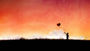 A Man Is Holding A Red Balloon In The Sky Wallpaper