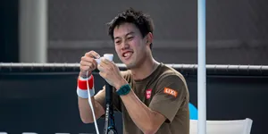 A Man Is Holding A Tennis Racket Wallpaper