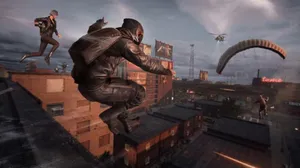 A Man Is Jumping Over A City With A Parachute Wallpaper