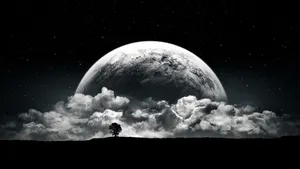 A Man Is Standing On A Hill With A Moon In The Background Wallpaper