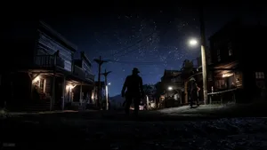 A Man Is Walking Down A Street At Night Wallpaper