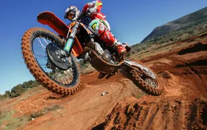 A Man Riding A Dirt Bike Wallpaper