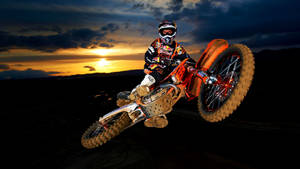 A Man Riding A Dirt Bike Wallpaper