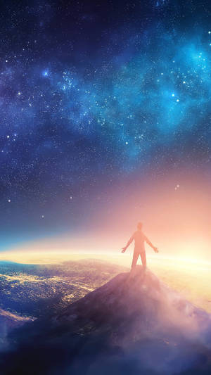 A Man Standing Atop A Mountain Peak, Enjoying The Beautiful View Wallpaper