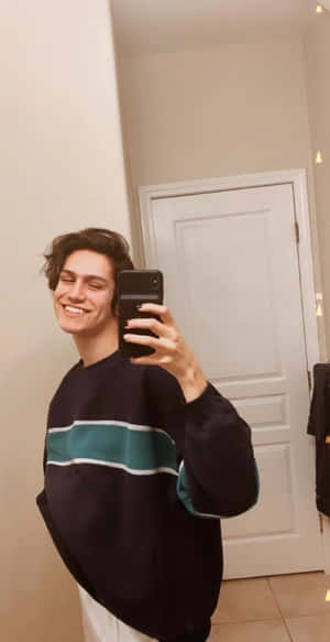 A Man Taking A Selfie In A Bathroom Wallpaper