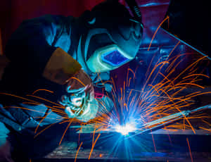 A Man Welding Metal Wallpaper