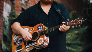 A Man With A Beard And A Guitar Wallpaper