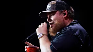 A Man With A Beard Is Holding A Microphone Wallpaper