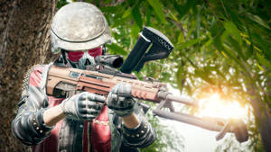 A Man With A Gun In Front Of Trees Wallpaper
