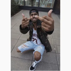 A Man With A Hat And Jeans Is Giving The Thumbs Up Wallpaper