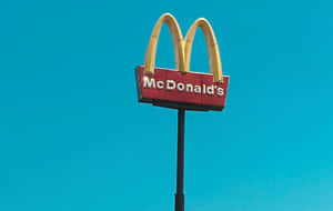 A Mcdonalds Sign With A Blue Sky Wallpaper
