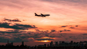 A Modern Plane Takes Off In The Sky Wallpaper