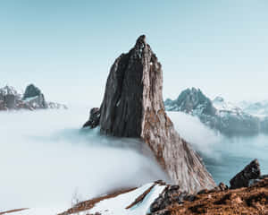 A Mountain With Clouds In The Background Wallpaper