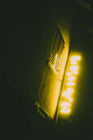 A Neon Sign On A Building Wallpaper