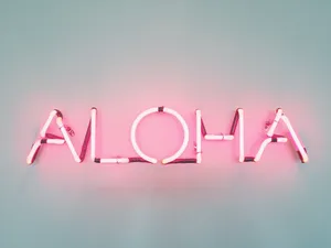 A Neon Sign With The Word Aloha On It Wallpaper