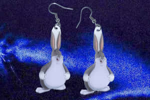 A Pair Of Cartoon Rabbit Earrings On A Blue Background Wallpaper