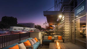 A Patio With Couches And Fire Pit At Dusk Wallpaper