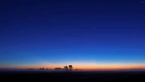 A Peaceful Blue Sunrise Paints The Sky Wallpaper