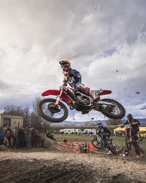 A Person Riding A Dirt Bike In The Air Wallpaper