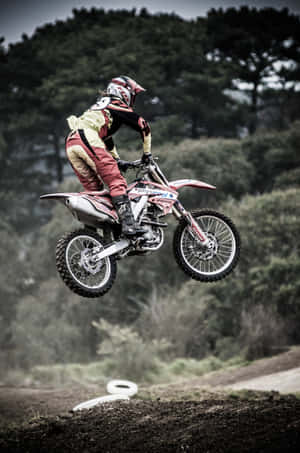 A Person Riding A Dirt Bike Wallpaper