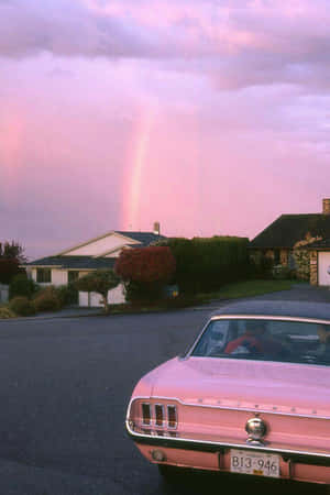 A Pink Car Parked In A Driveway Wallpaper