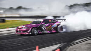 A Pink Drift Car Is Driving Down A Track Wallpaper