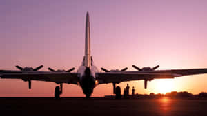 A Pink Plane Flying Across A Blue Sky Wallpaper