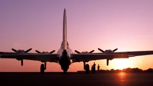 A Pink Plane Flying Across A Blue Sky Wallpaper