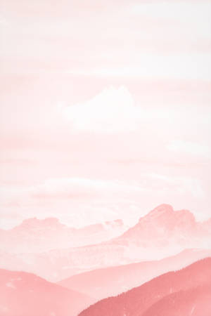 A Pink Sky With Mountains Wallpaper