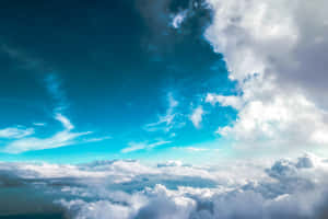 A Plane Flying Over The Clouds Wallpaper