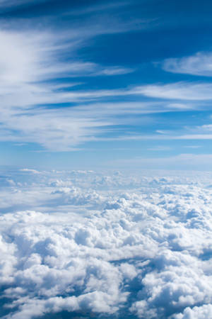 A Plane Flying Over The Clouds Wallpaper