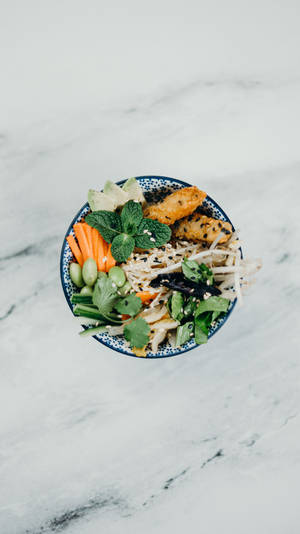 A Plate Of Vegetables On A Marble Table Wallpaper