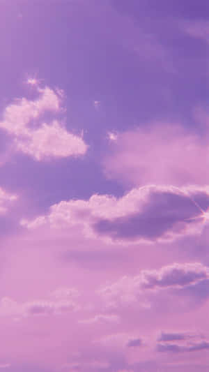 A Purple Sky With Clouds And Stars Wallpaper