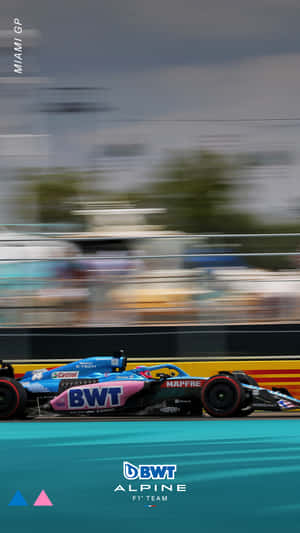 A Racing Car On A Track With Blurred Background Wallpaper