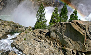 A Radiant Rainbow Newly Created Against A Mountain Landscape Wallpaper