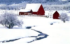 A Red Barn In The Snow With A Stream Wallpaper
