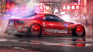 A Red Car Driving Down A City Street Wallpaper