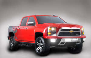 A Red Chevrolet Silverado Truck Is Shown In A Gray Background Wallpaper