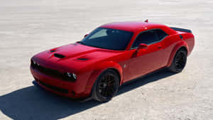 A Red Dodge Challenger Parked In A Parking Lot Wallpaper