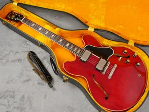 A Red Guitar Is Sitting In A Case With A Cord Wallpaper