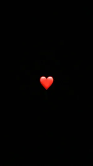 A Red Heart Is Lit Up In The Dark Wallpaper