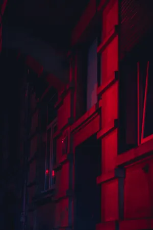A Red Light Is Shining On A Building Wallpaper