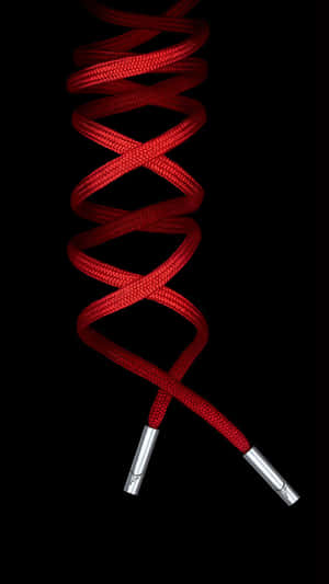 A Red Shoelace With A Silver Ring On It Wallpaper