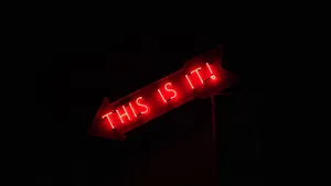 A Red Sign On A Pole Wallpaper