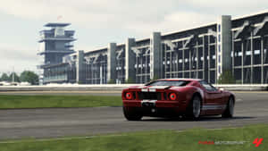 A Red Sports Car Driving On A Race Track Wallpaper