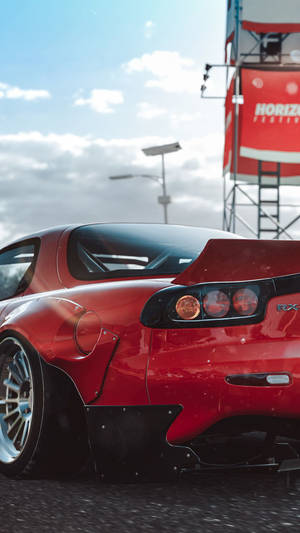 A Red Sports Car Is Parked In A Parking Lot Wallpaper