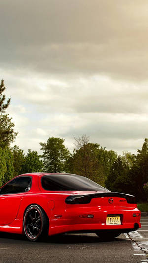 A Red Sports Car Parked On A Street Wallpaper