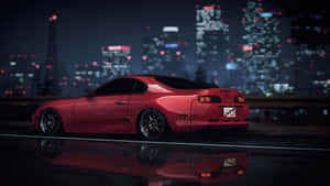 A Red Sports Car Sitting On A Street At Night Wallpaper