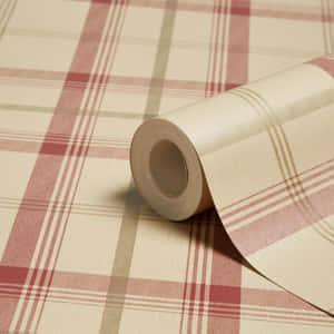 A Roll Of Plaid Wallpaper On A Table Wallpaper